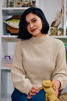 A beautiful woman in a joyful moment, posing with her two adorable bearded dragon pets, radiating love and companionship.