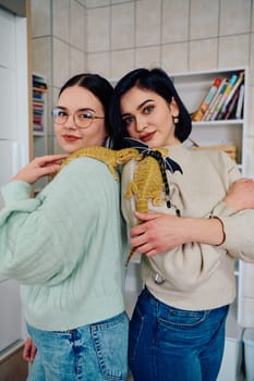 The sisters' smiles and the lizard's calm demeanor suggest that they are all enjoying each other's company.