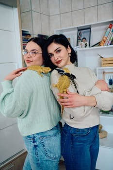 The sisters' smiles and the lizard's calm demeanor suggest that they are all enjoying each other's company.