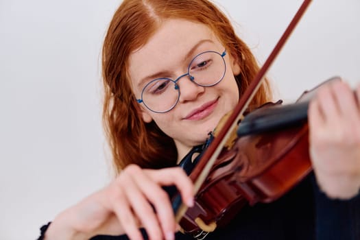 A stunning redhead musician exudes elegance as she poses with her violin, embodying both grace and musical prowess.