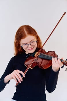 A stunning redhead musician exudes elegance as she poses with her violin, embodying both grace and musical prowess.