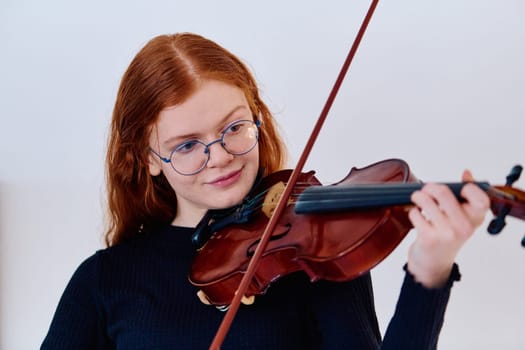 A stunning redhead musician exudes elegance as she poses with her violin, embodying both grace and musical prowess.