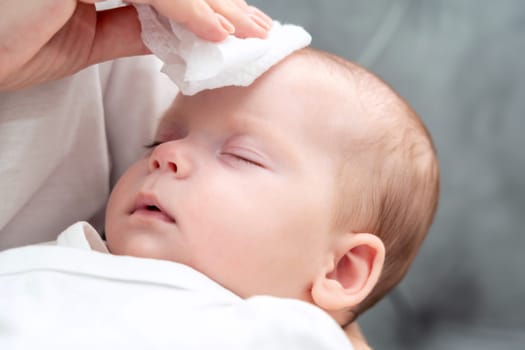 Wet wipe brings relief to newborn, Concept of maternal instinct during health concern