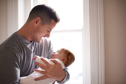 Father, baby and home window with care, love and support together with family bonding and development. Dad, smile and young child in a house with kid and parent happy and proud about infant growth.