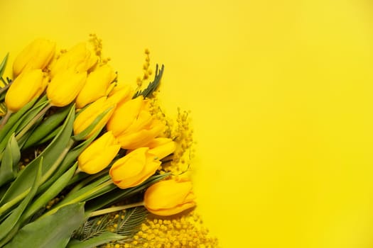 Bouquet of yellow tulips on a yellow background, top view of a floral banner,