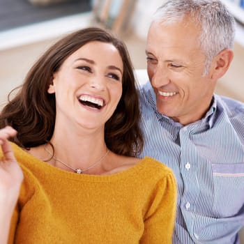 Couple, happiness and laughing on sofa for love with support, trust and comic joke in living room of house. Senior man, woman and funny in home with embrace, affection and relationship in apartment.