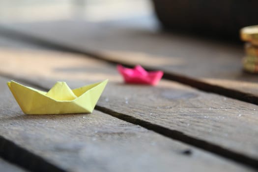 Origami made paper sailing boat. Summer time concept.