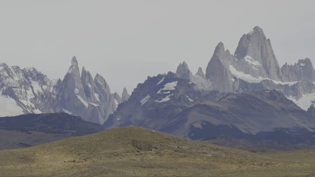 Panoramic video showcases the stunning snowy peaks of Fitz Roy and Cerro Torres in Chalten's mountain range.