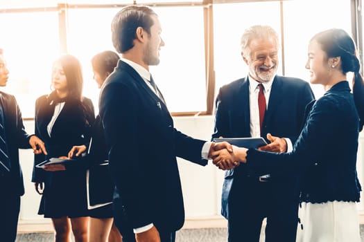 Many young businessmen and businesswomen in group meeting standing at conference hall in office. Multicultural company organization unity and support. Concept of partnership and human resources. uds