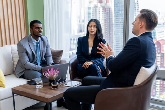 African businessman present start up project to expert investor. Group of multicultural business team solving problems, discussing business idea with skyscraper at modern business lounge. Ornamented