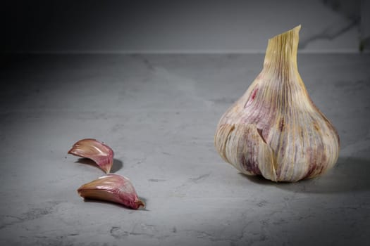Still life photo of organic whole garlic on a light stone background 3