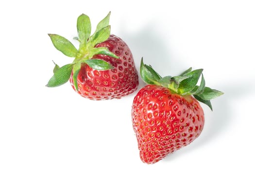 Two strawberries close up on white background 2