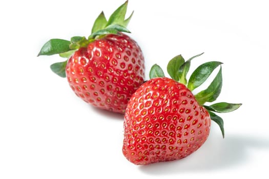 Two strawberries close up on white background 1
