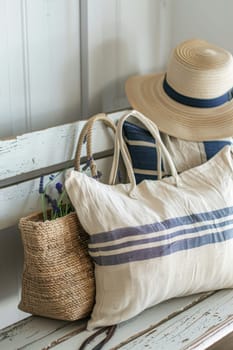 Close-up of a summer beach bag and hat on a sandy beach.