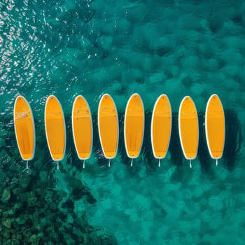 A set of yellow surfboards on a blue sea background.
