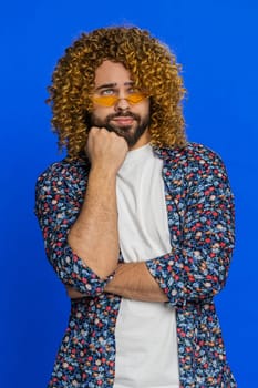 Caucasian man tired bored indifferent expression, exhausted of tedious story, not interested in communication talk, displeasure, uninteresting. Stylish guy isolated on studio blue background. Vertical