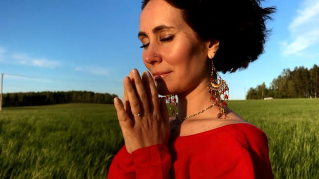 Believing woman with her eyes closed asking for forgiveness and peace. Stock clip. Feeling unity with nature