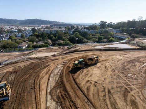 Aerial view of heavy construction equipment working at the construction site. San Diego, California, March, 10th, 2024