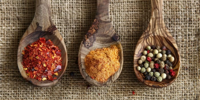 Spices in wooden spoons rustic setting culinary inspiration..