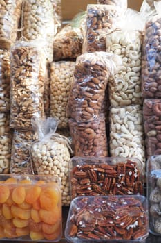 many mixed nuts in a plastic packet on shelf . High quality photo