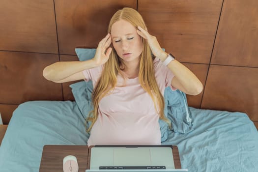 Weary pregnant woman, tired of working from home, navigates the challenges of balancing professional tasks with pregnancy demands.