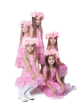 Five little girls in pink dresses and wreaths. Isolated on white