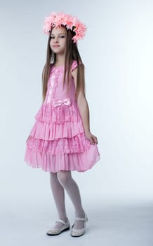 Full length portrait of little girl in beautiful pink dress
