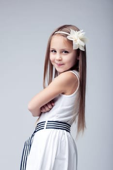 Studio portrait of little girl in white dress