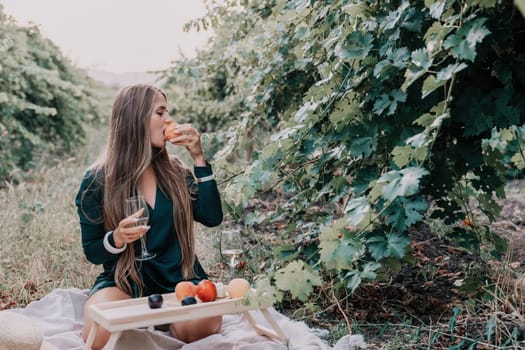 Picnic and wine tasting at sunset in the hills of Italy, Tuscany. Vineyards and open nature in the summer. Romantic dinner, fruit and wine.