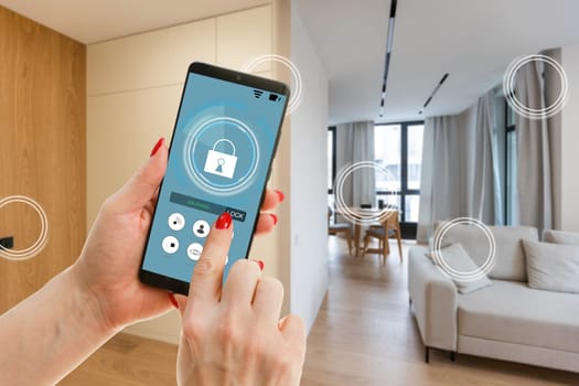 Young woman holding smart phone with launched security application at home. Concept of controlling and managing home security from a mobile device.