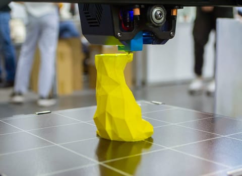 3D printer prints an object. The process of printing model on 3D printer. Model printed on 3D printer from molten plastic. 3D printing technologies. Additive progressive new modern printing technology