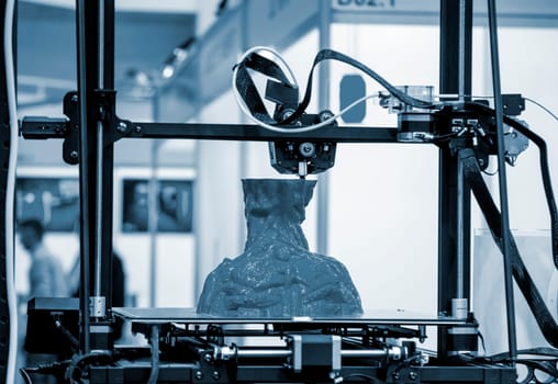 3D printer prints an object. The process of printing model on 3D printer. Model printed on 3D printer from molten plastic. 3D printing technologies. Additive progressive new modern printing technology