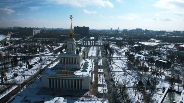 Top view of large square with historical architecture in winter. Creative. Historic square with alleys and Soviet architecture in city center. Winter landscape with Soviet architecture on background of horizon with city.