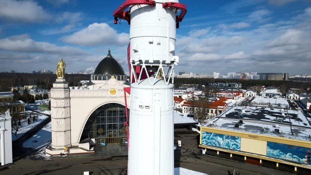 Rocket on city square in winter. Creative. Top view of monument to space flight in center of historical square of city. Beautiful view of rocket monument in honor of flight into space on winter day.