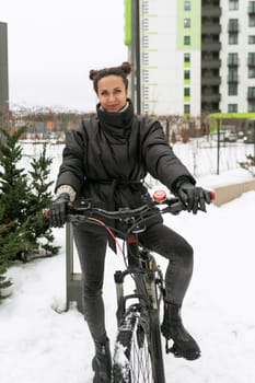 Sports concept, young woman riding a sports bike in winter.