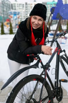 A woman stopped while cycling to rest.