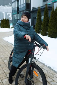 A healthy pensioner woman went for a bike ride in the cold.