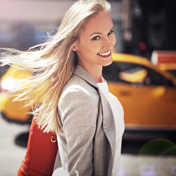 Woman, portrait and smile with urban, walk and commute for work or career. Designer, job and new york street with city, summer and happiness with confident and creative business travel in downtown.