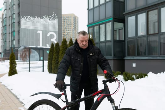 European elderly man rents a bicycle to ride around the city.