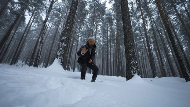 Man raps in winter forest. Media. Stylish man moves in hip hop style in winter forest. Man reads hip hop in winter forest.