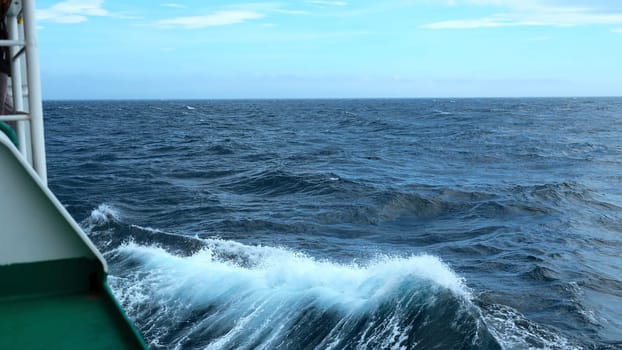 Waves from floating sea vessel. Clip. Beautiful moving waves from floating ship at sea. Beautiful sea horizon with moving waves from ship.