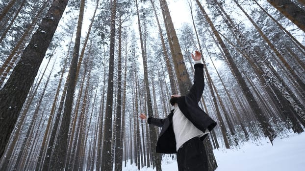 Man dancing in winter forest. Media. Stylish man filming video clip in winter forest. Shooting stylish man in winter forest.