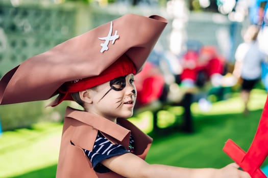 Boy Cat Pirate costume. Halloween party in kindergarten. Aqua makeup painted kids face. Bright festive.