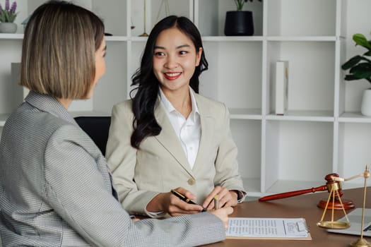 Lawyer working with client discussing contract document in office, consulting to help customer.