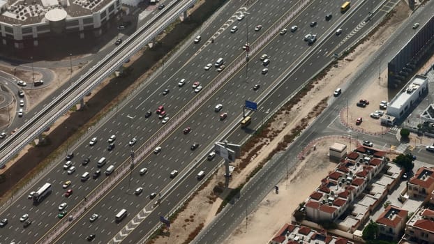 Aerial view of busy highway with traffic in the rush hour. Action. Multi lane road with many cars driving fast