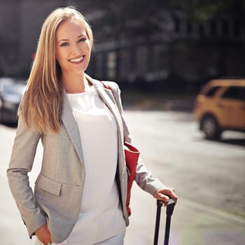 Business woman, baggage and portrait in city with smile for journey with pride, suit and outdoor. Person, happy and luggage for travel in street on metro sidewalk by skyscraper buildings in New York.