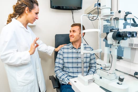 Female doctor and patient talking and smiling in ophthalmology clinic