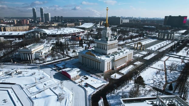 Top view of large square with historical architecture in winter. Creative. Historic square with alleys and Soviet architecture in city center. Winter landscape with Soviet architecture on background of horizon with city.