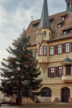 Winter Festivities in Bitigheim-Bissingen: Charming Half-Timbered Houses Adorned with Christmas Decorations. Step into the enchanting New Year's atmosphere of Bitigheim-Bissingen, Baden-Württemberg, Germany, where half-timbered houses line the streets, beautifully decorated with festive Christmas ornaments. The photograph is artfully processed in warm vintage tones, capturing the essence of winter joy in this picturesque town.