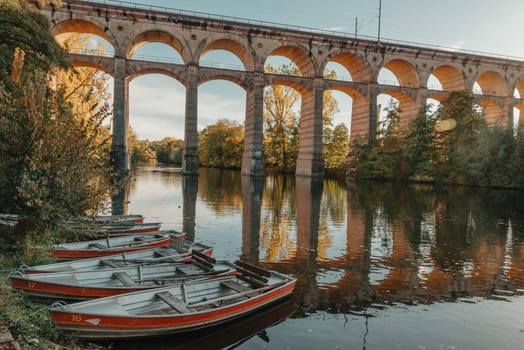 Railway Bridge with river in Bietigheim-Bissingen, Germany. Autumn. Railway viaduct over the Enz River, built in 1853 by Karl von Etzel on a sunny summer day. Bietigheim-Bissingen, Germany. Old viaduct in Bietigheim reflected in the river. Baden-Wurttemberg, Germany. Train passing a train bridge on a cloudy day in Germany